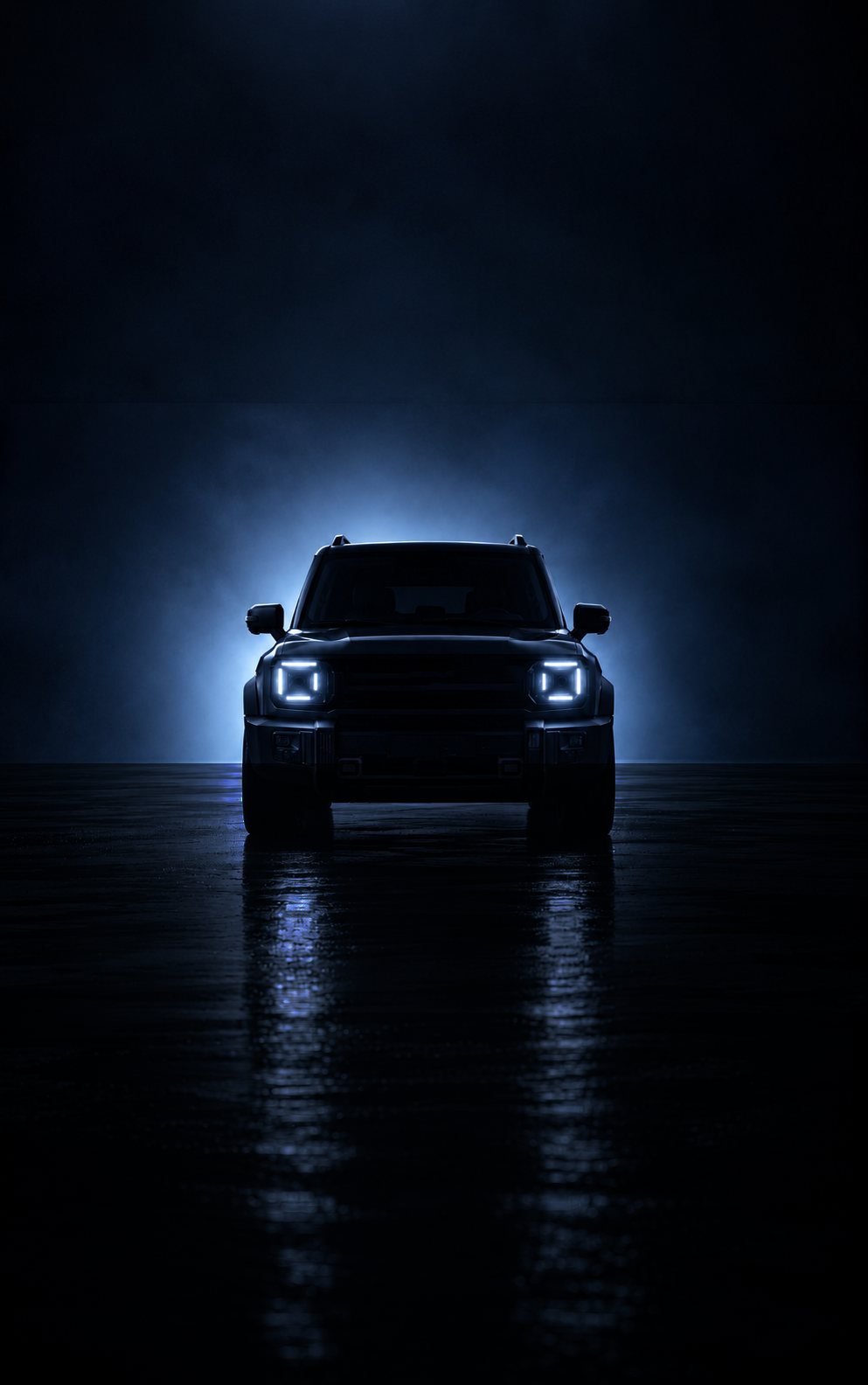 A next-generation vehicle in silhouette, its headlamps lit against a dark blue haze